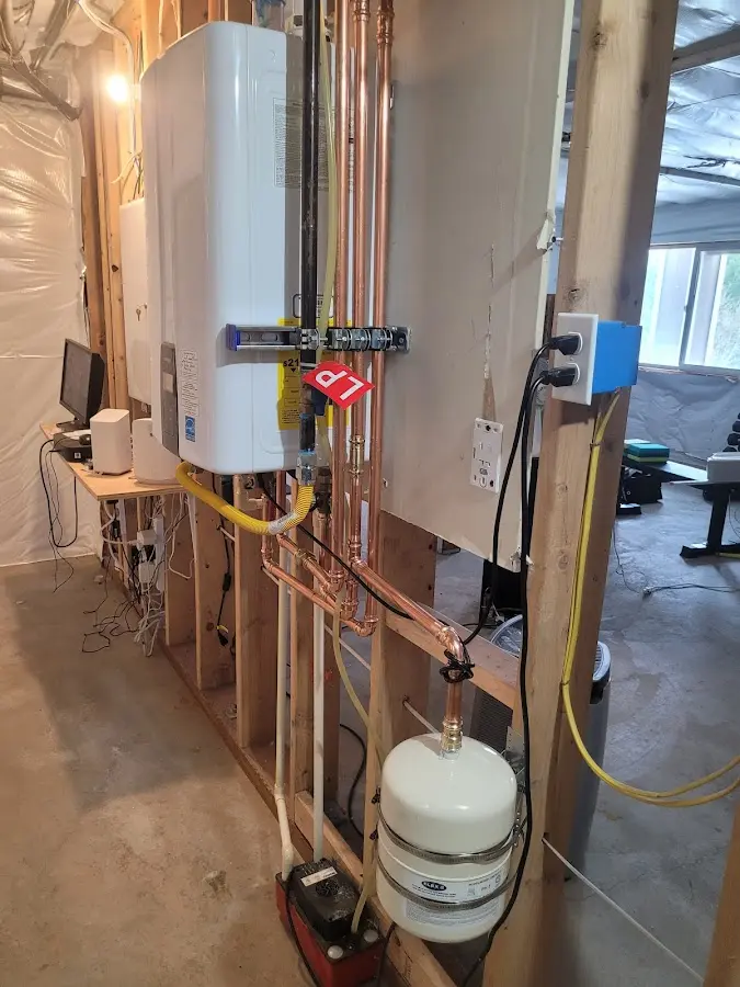 Licensed plumber repairing a kitchen sink in Granby